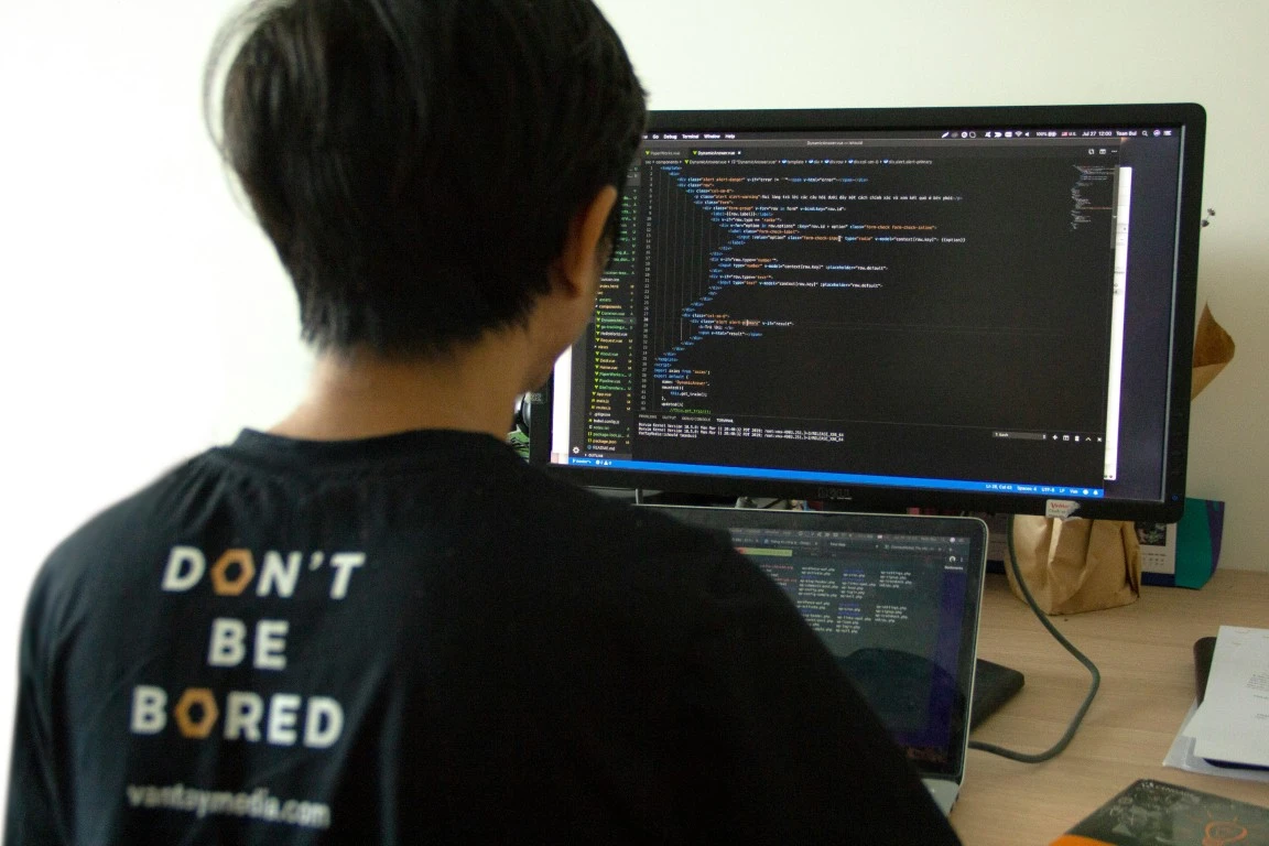 Man sitting at desk coding a professional new website